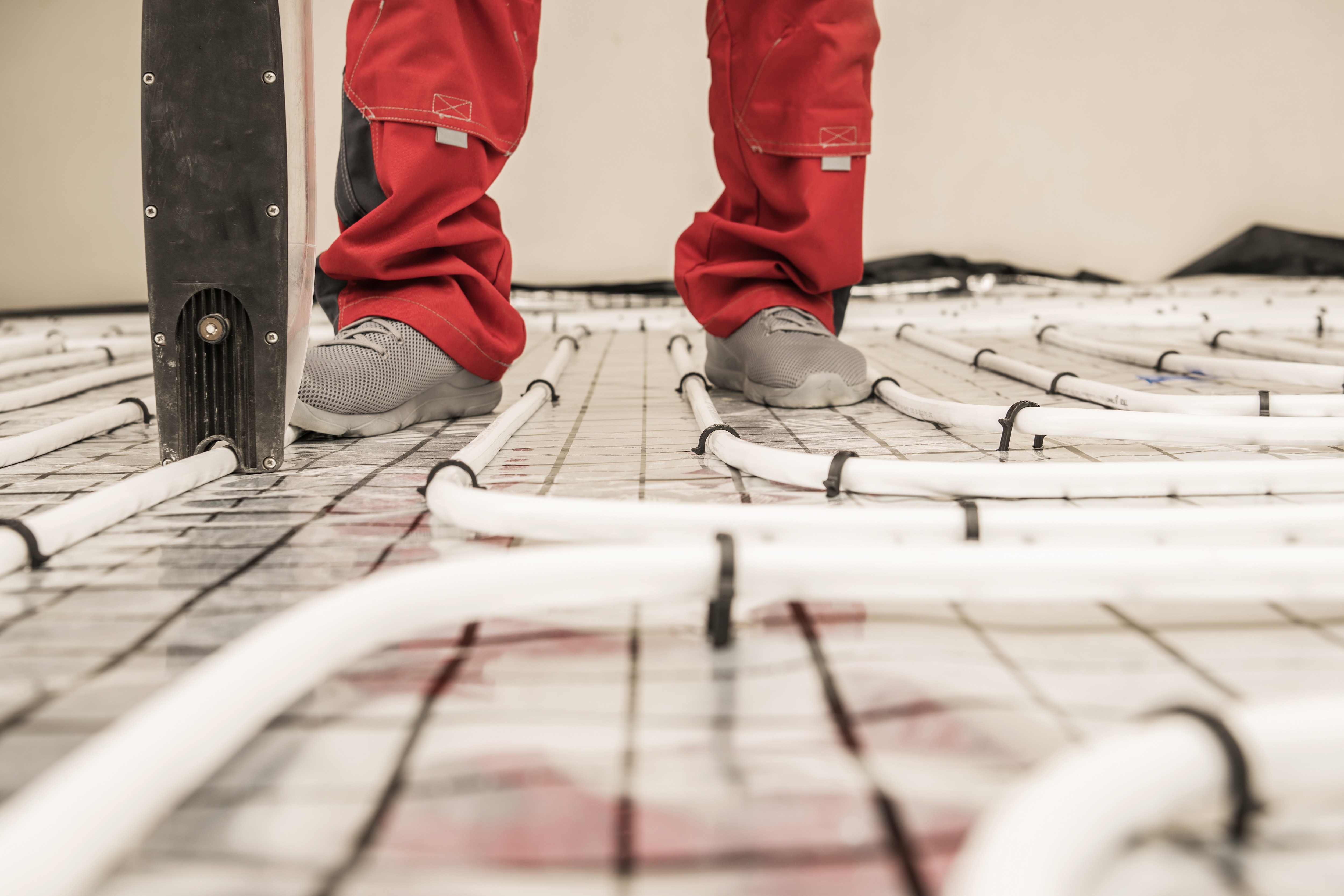 Engineer working on an underfloor heating system